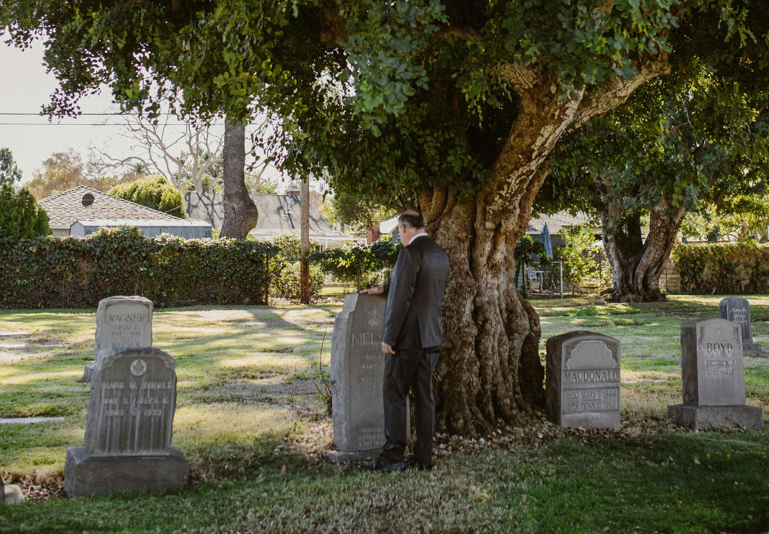 Man standing over a headstone in Cornwall and SDG